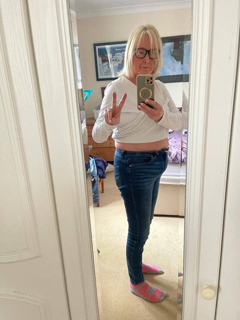 Emma Skeates posing in mirror and jeans