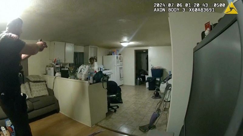 In this image taken from body camera video released by Illinois State Police on Monday, July 22, 2024, former Sangamon County Sheriff's Deputy Sean Grayson, left, points his gun at Sonya Massey, who called 911 for help, before shooting and killing her inside her home in Springfield, Ill., July 6, 2024. (Illinois State Police via AP)
