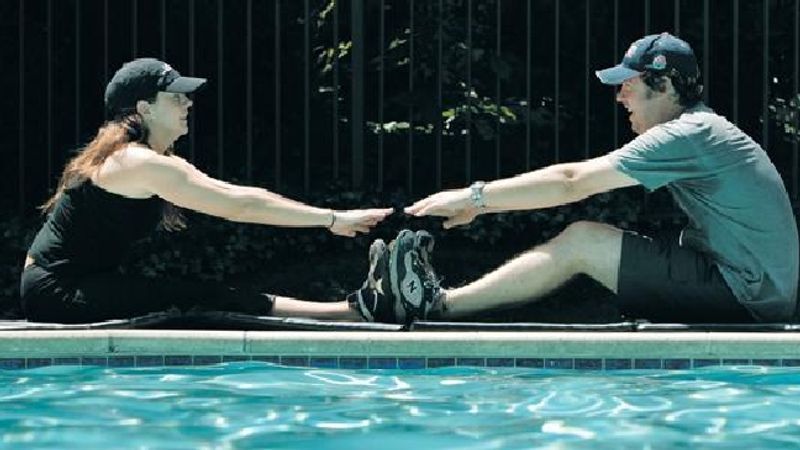 Brian Costello and his fiancee, Kristi Hennessey ,work out at their home in Los Angeles. - AP