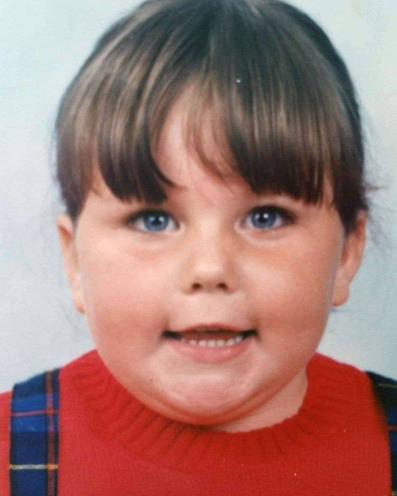 Chrissy Metz with blue eyes and bangs smiling in a school photo