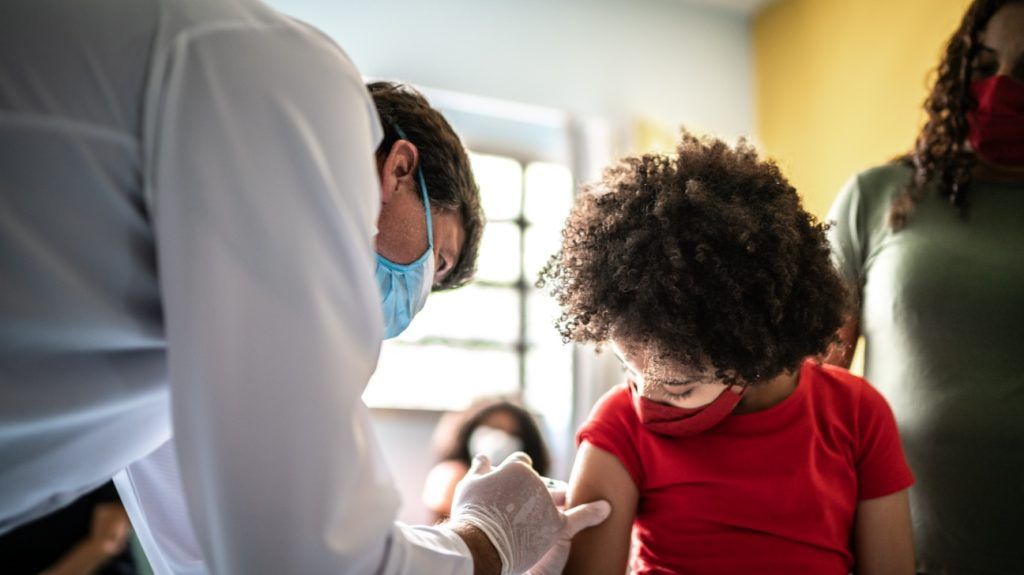 Child getting vaccinated in vaccination center