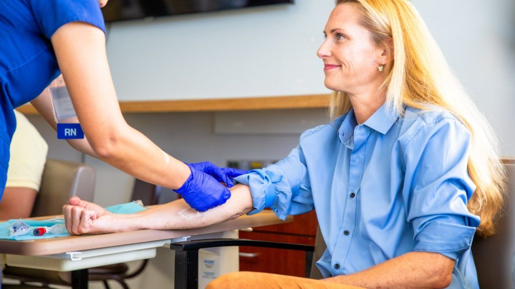 A registered nurse taking a blood draw.