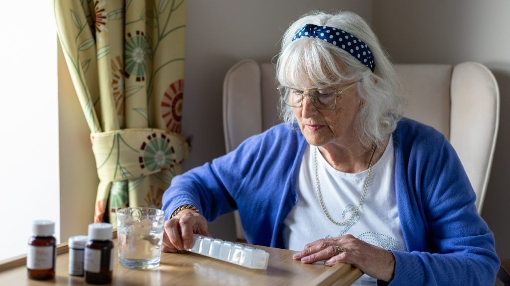 older white woman sorting medication