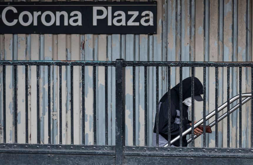 A person wears a face mask while walking to the subway in Corona, Queens, on April 29, 2020 in New York City.