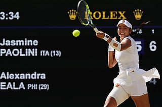 Philippines' Alexandra Eala returns to Italy's Jasmine Paolini during their women's singles round of 16 tennis match on the eighth day of the 2026 Wimbledon Championships at The All England Lawn Tennis and Croquet Club in Wimbledon, southwest London, on July 6, 2026.