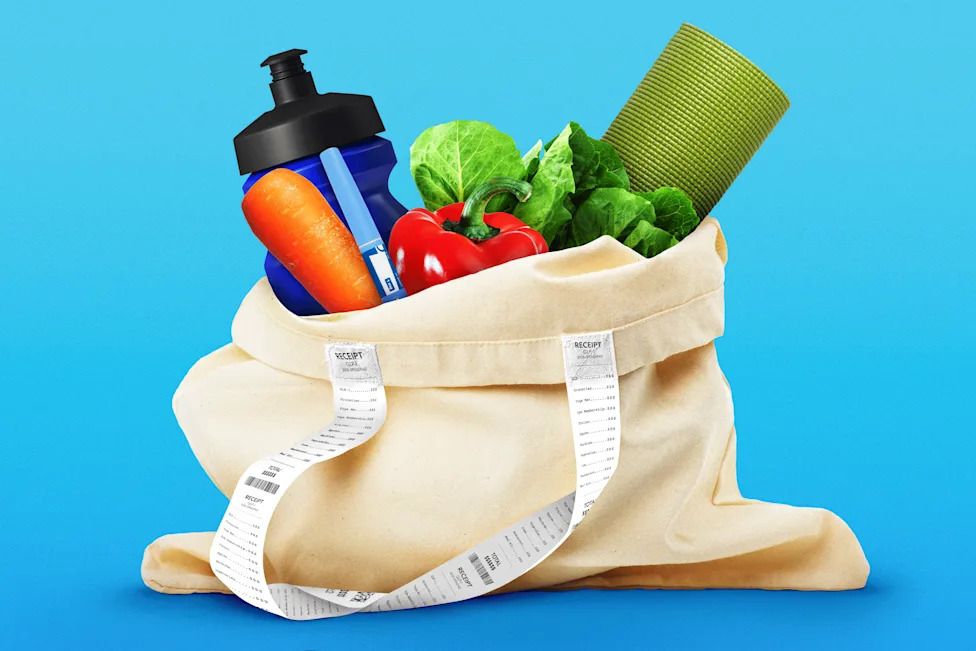 Canvas grocery bag filled with vegetables, a water bottle, thermometer and rolled exercise mat, wrapped with long receipts.