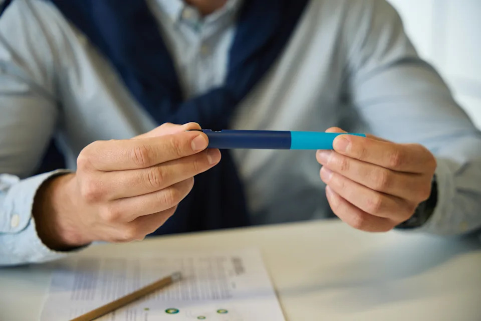 A man holds a prefilled semaglutide injection pen.