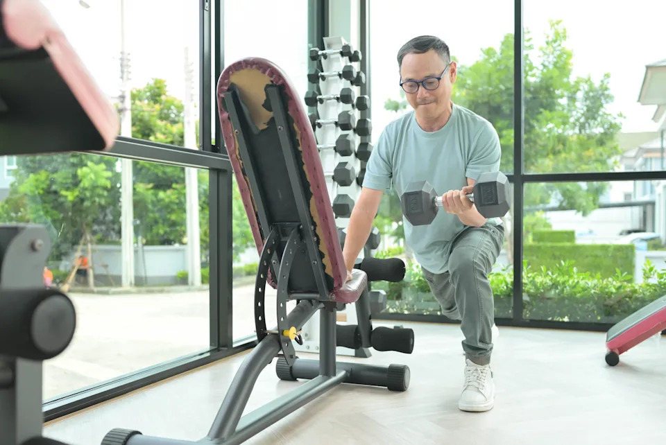 A person doing a resistance workout with dumbbells.