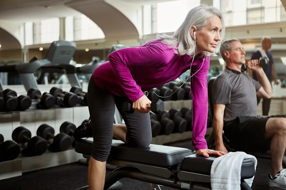Older woman doing resistance training with dumbbells to prevent muscle loss and protect bone density while taking GLP-1 medication