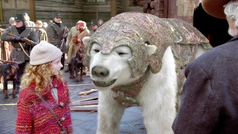 A young girl in a winter outfit stands next to an armored polar bear with bystanders in the background. The scene appears to be set in a historical or fantasy context