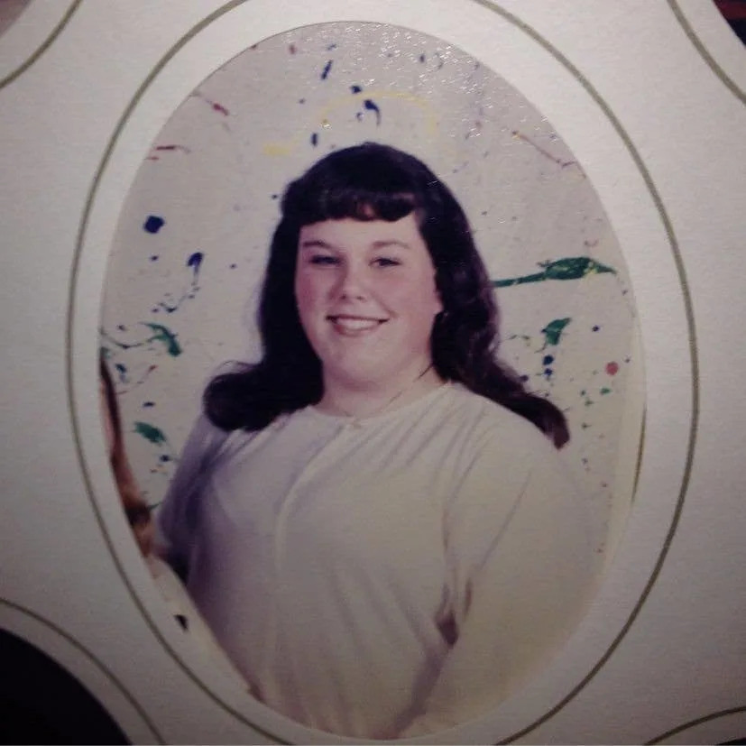 Chrissy Metz as a teenager smiling with short bangs in an old fashioned photo