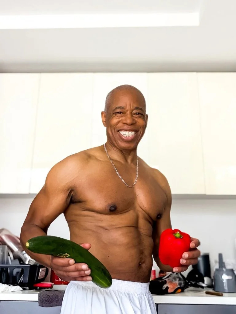 Ex-NYC Mayor Eric Adams posted a shirtless selfie on X clutching a foot-long cucumber and a red bell pepper to promote healthy eating. X/ericadamsfornyc