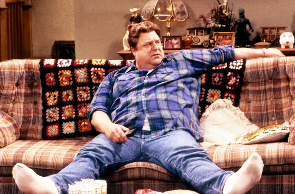 Goodman is best known for playing Dan Conner on "Roseanne" and its spinoff, "The Conners." (He's seen as his character here in a 1995 episode.) ©Carsey-Werner Co/Courtesy Everett Collection
