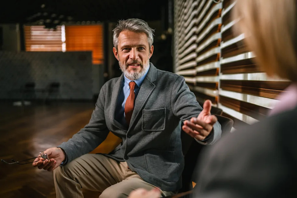 Mature businessman communicating and gesturing during informal business meeting