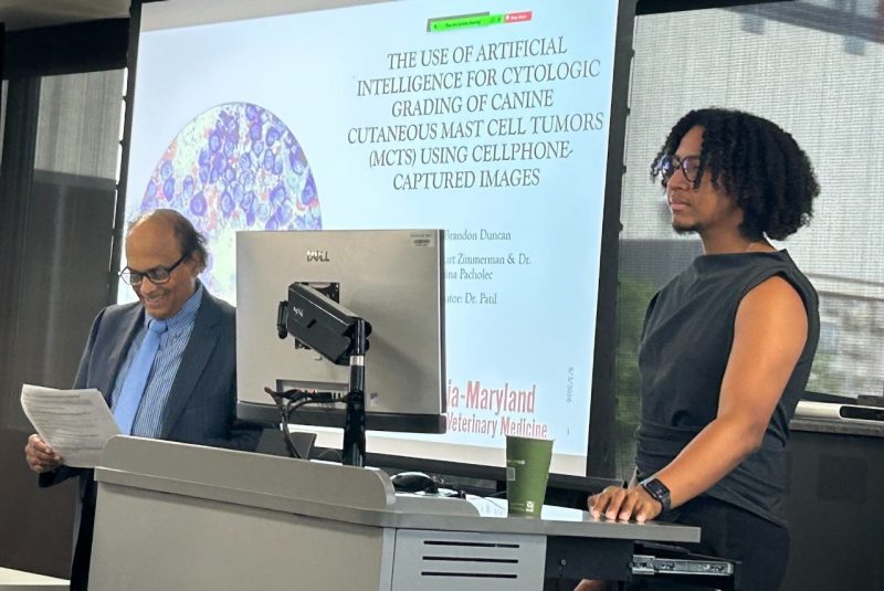 S. Ansar Ahmed and second year veterinary student Brandon Duncan during his presentation at the Summer Veterinary Student Research Program. Ahmed is introducing Duncan before his presentation