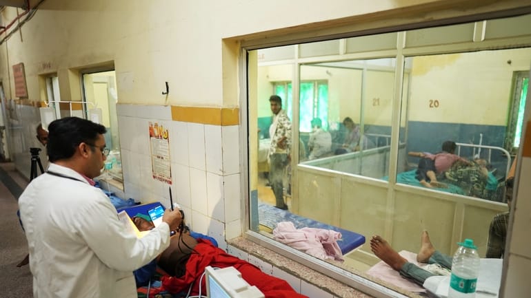 Dr. Abhishek Pranayami examines a patient suffering from a heat-related...