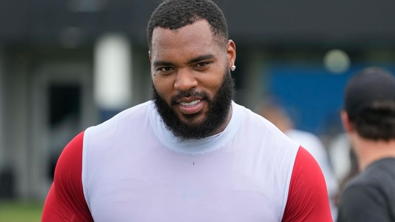 Tennessee Titans defensive tackle Jeffery Simmons walks off the field...