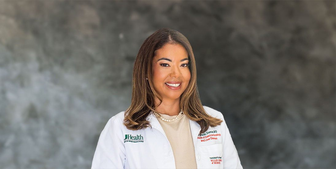 Dr. Oriana Damas, smiling, in white clinic coat