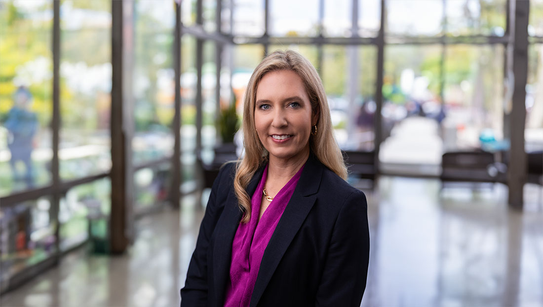 Dr. Tracy Crane, in dark jacket and purple top