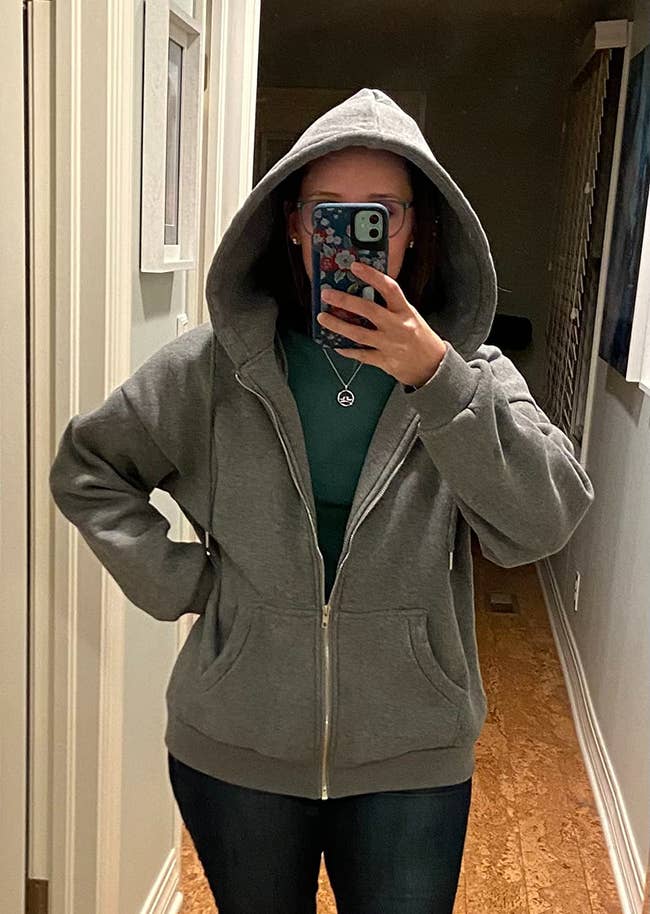 A reviewer wearing the hoodie indoors