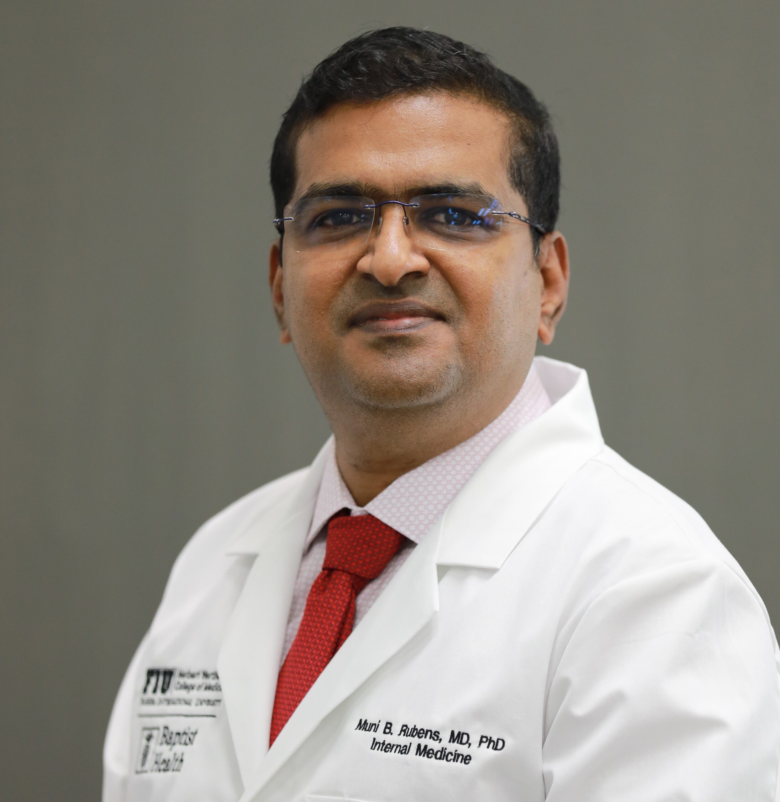 Professional headshot of Dr. Muni Rubens