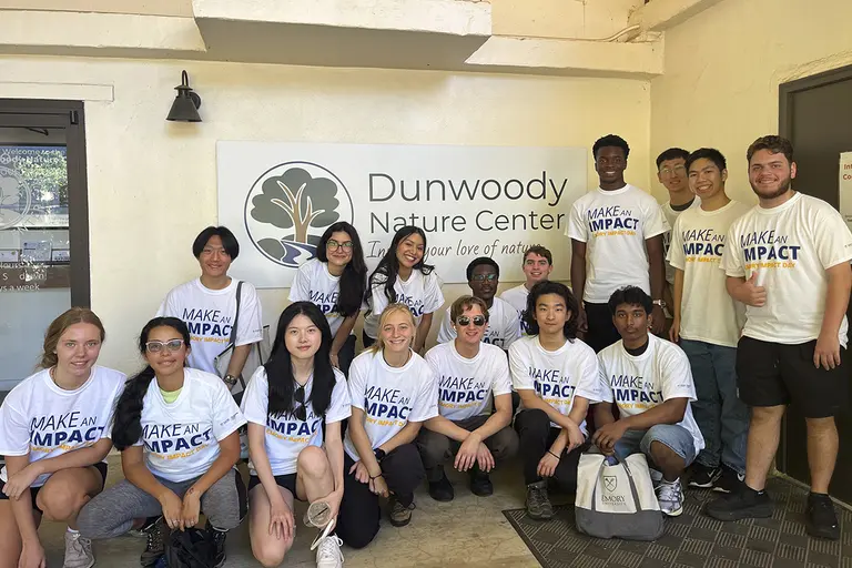 group of students wearing matching Emory Impact Day volunteer shirts