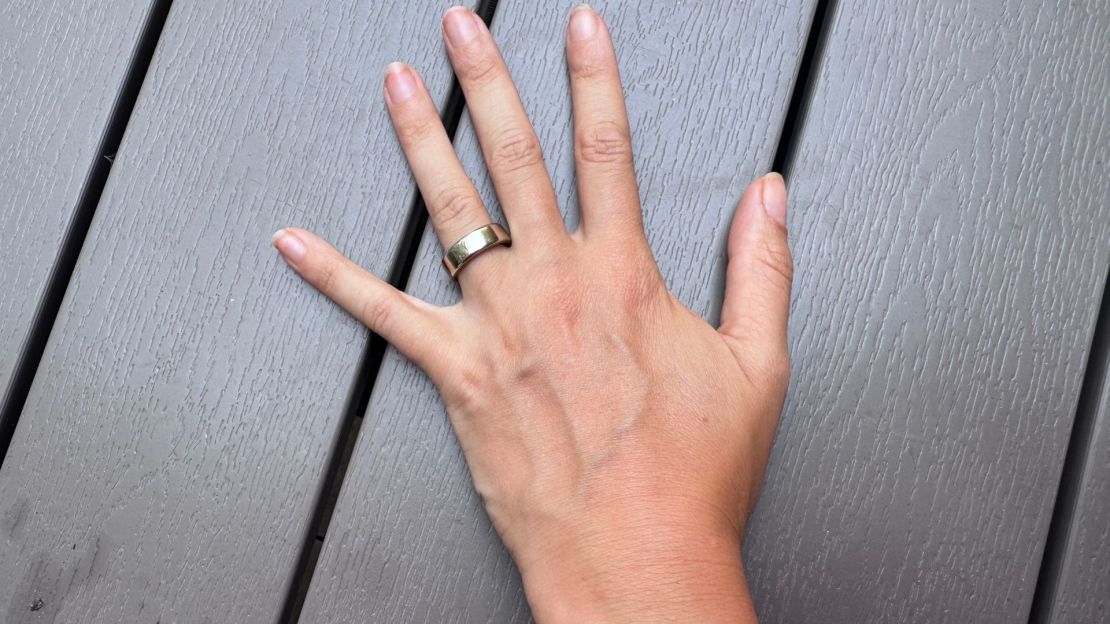 A woman wearing the Oura Ring 5 on her hand.