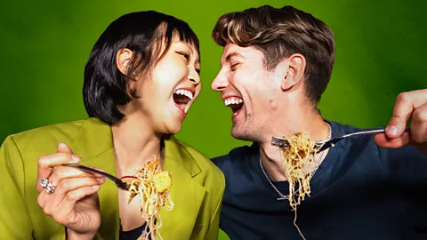BBC/ Serenity Strull/ Getty Images A man and a woman laughing while eating spaghetti (Credit: BBC/ Serenity Strull/ Getty Images)