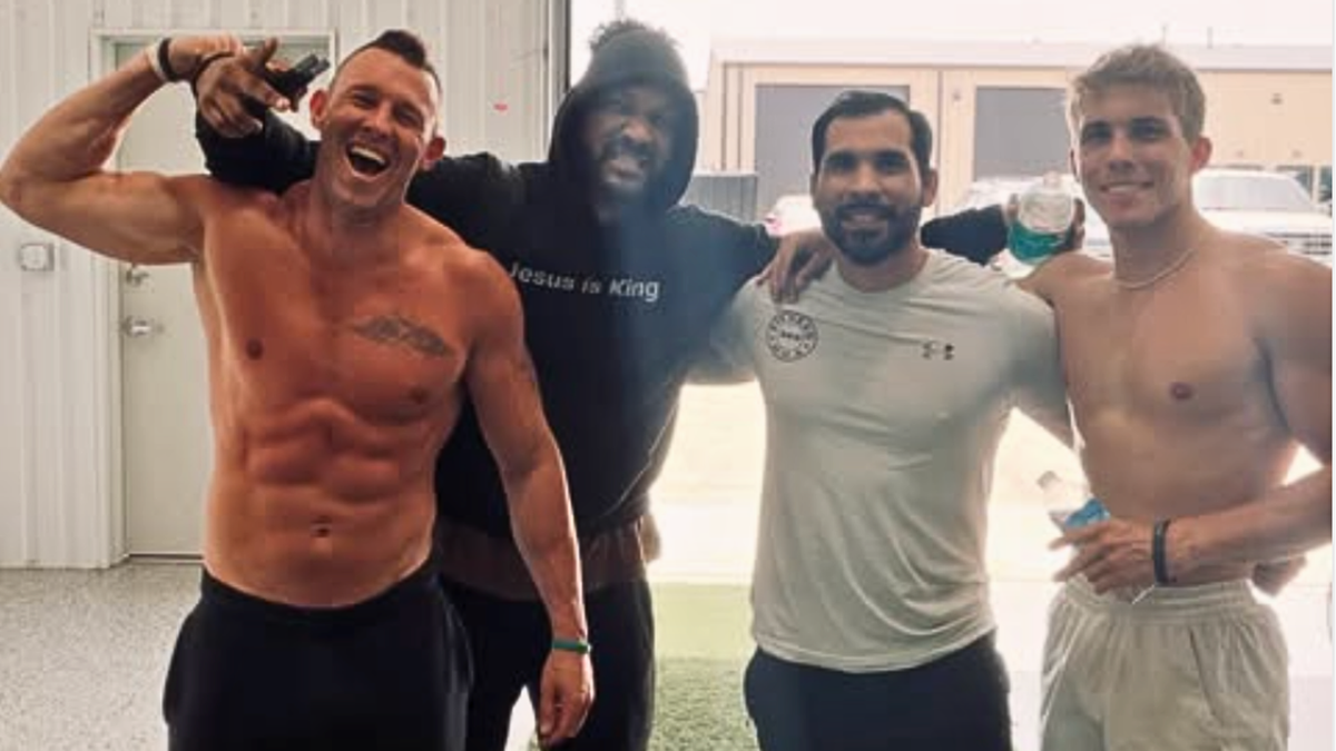 men pose for gym selfie together after workout