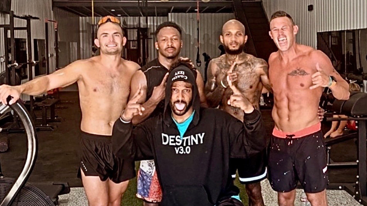 men pose for gym selfie together after workout