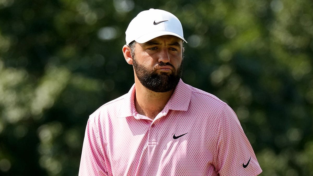 Scottie Scheffler reacts after missing a putt on the first hole.