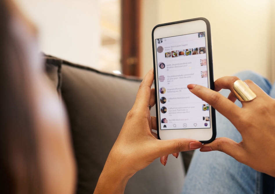 A person scrolls on a phone.