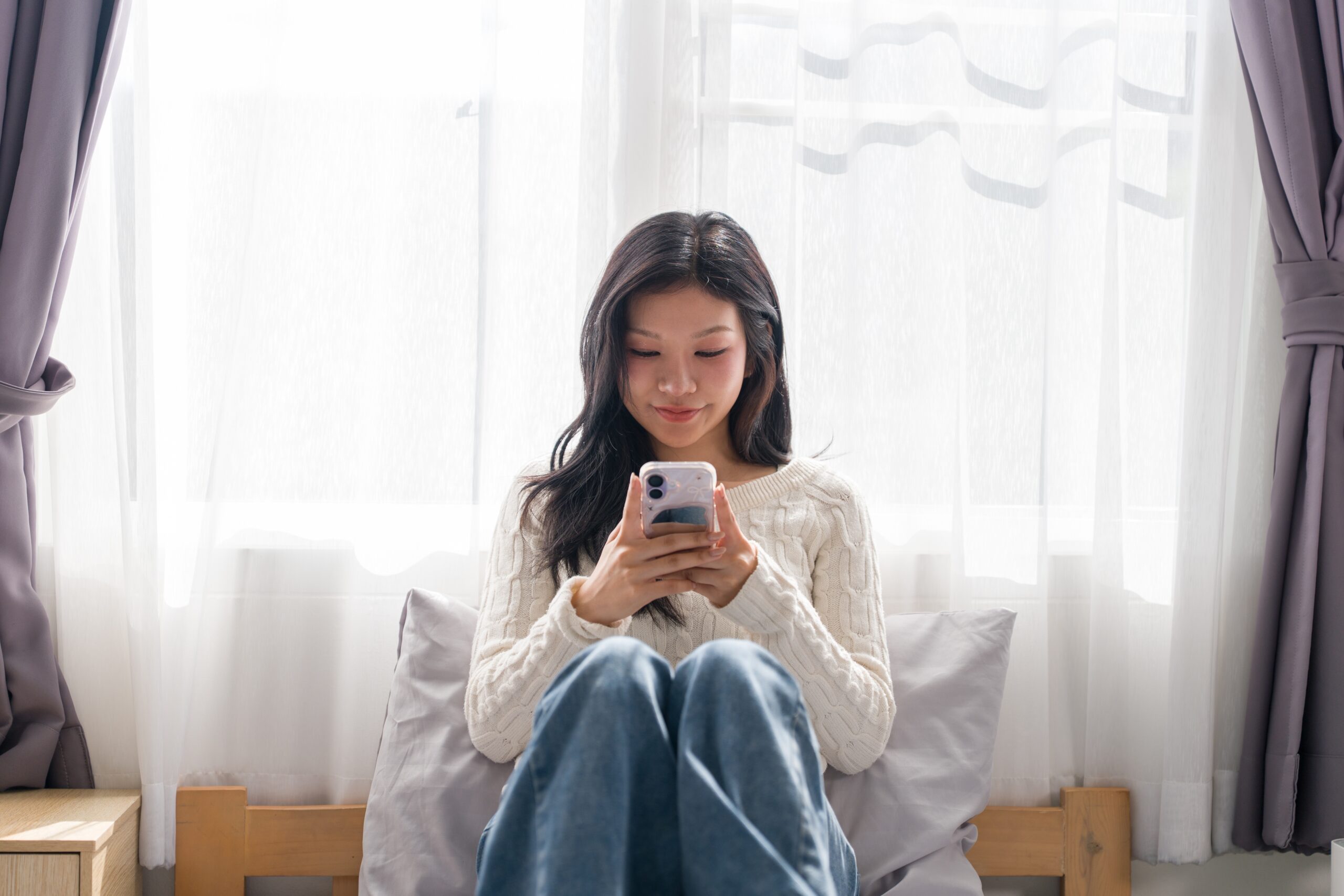 A female looking at her phone.