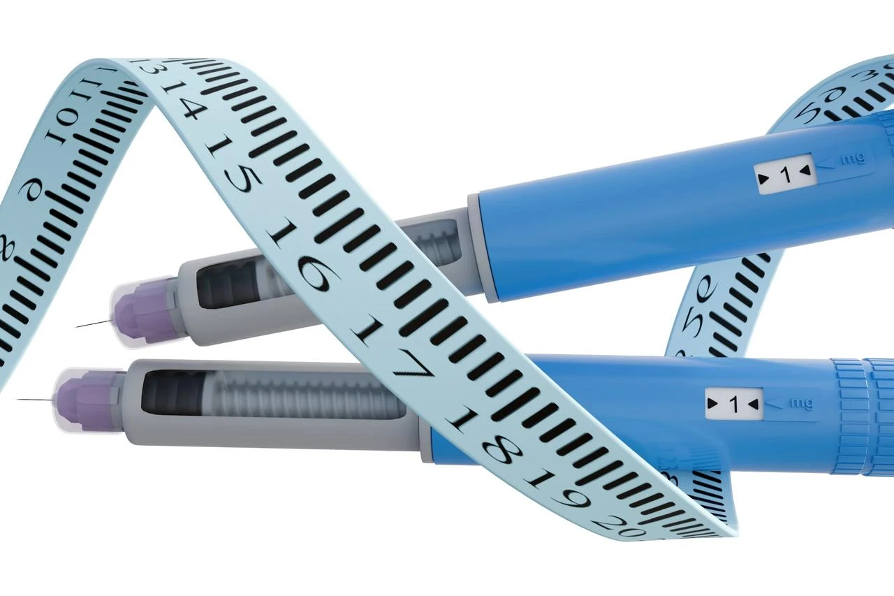 Two injection pens for weight loss, shown alongside a body measuring tape. (Adobe Stock Photo)