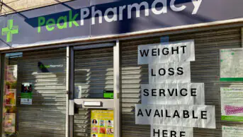 Weight-loss service advertised in pharmacy shop window