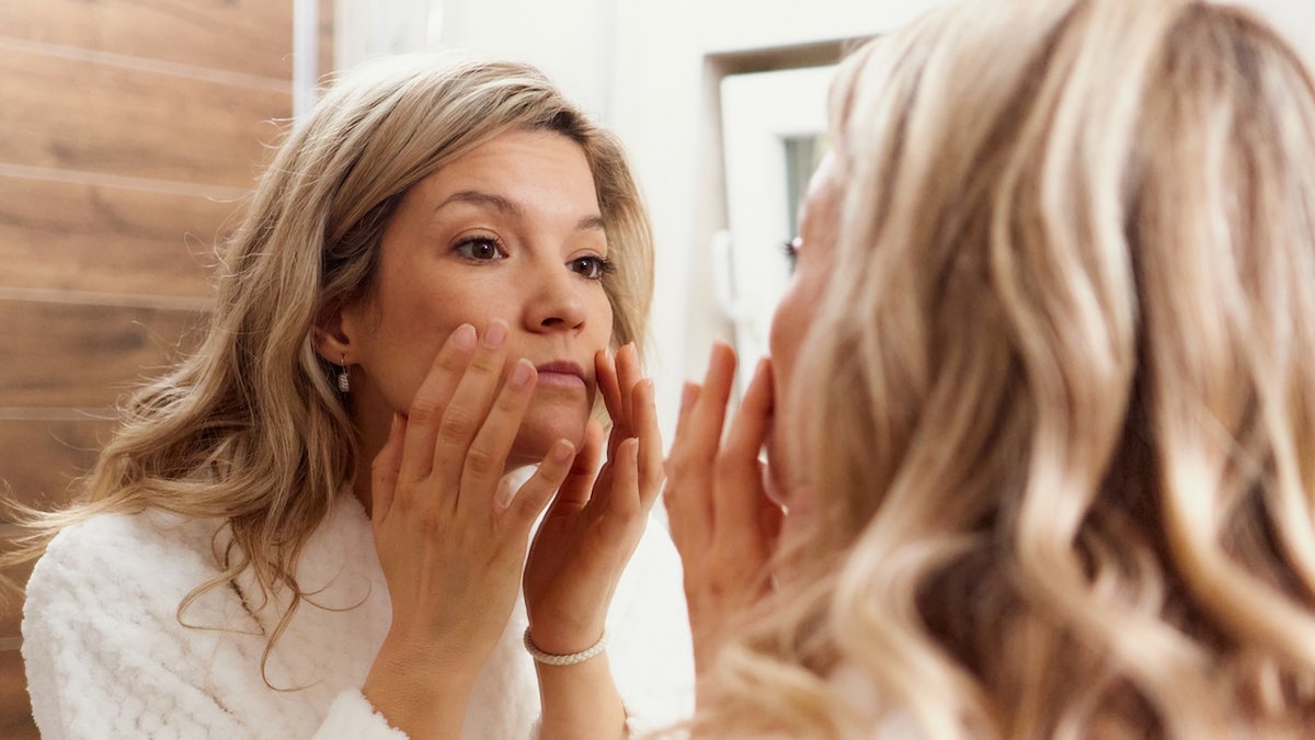 Woman looking in mirror