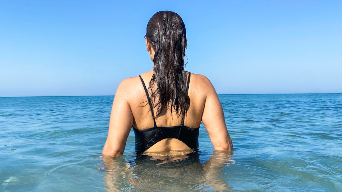 Woman wading in ocean