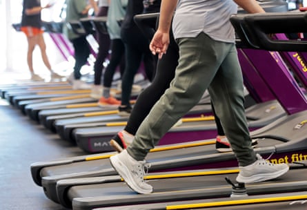 People walking on a row of treadmills