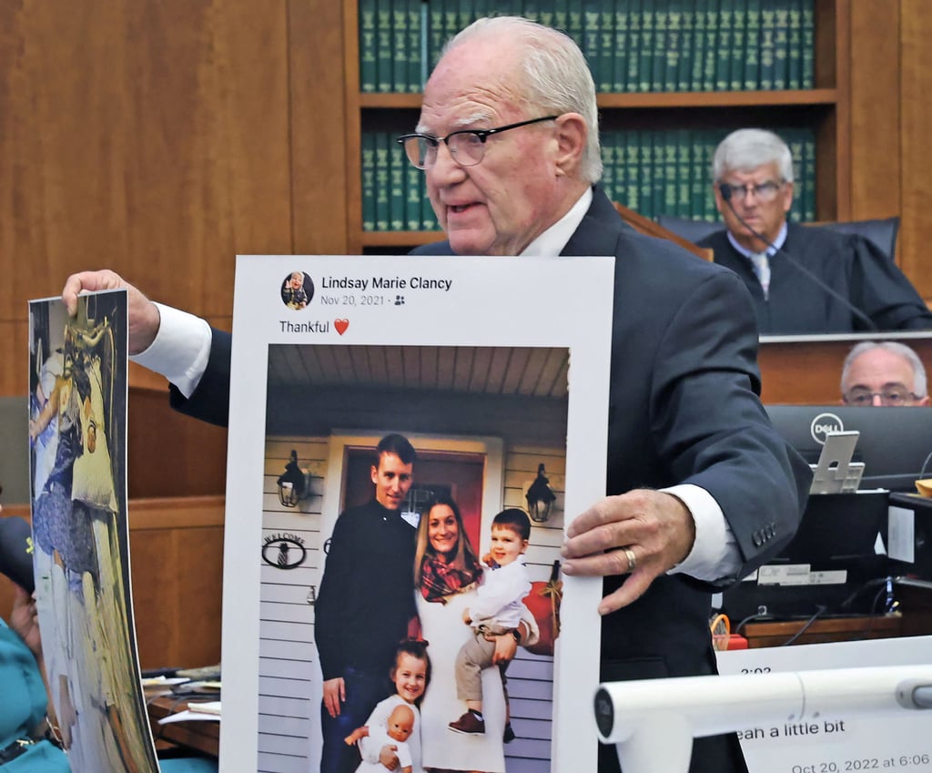Defence lawyer Kevin Reddington holds up a picture of the Clancy family. Photo: Reuters