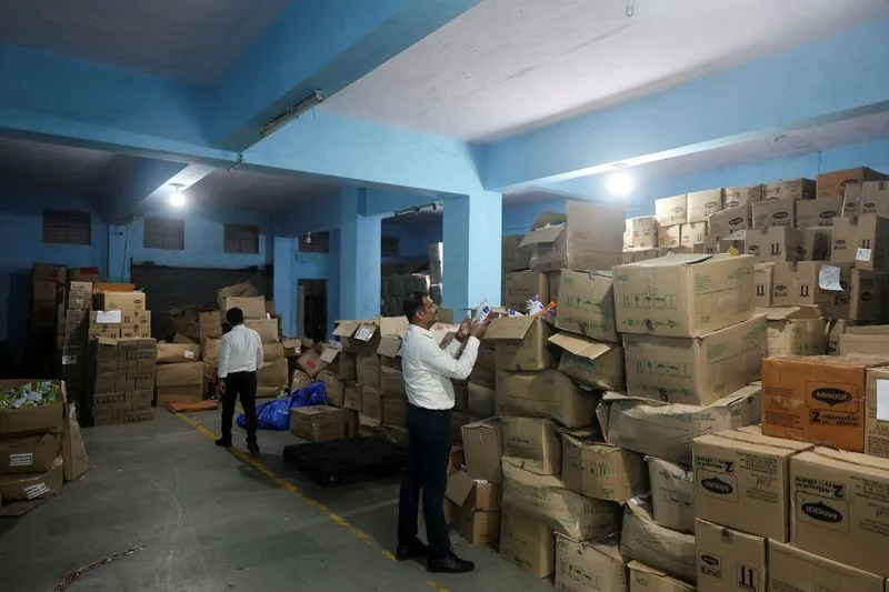 Maharashtra Food and Drug Administration officials raid a warehouse in Turbhe