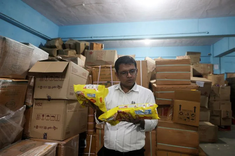 Maharashtra Food and Drug Administration officials raid a warehouse in Turbhe
