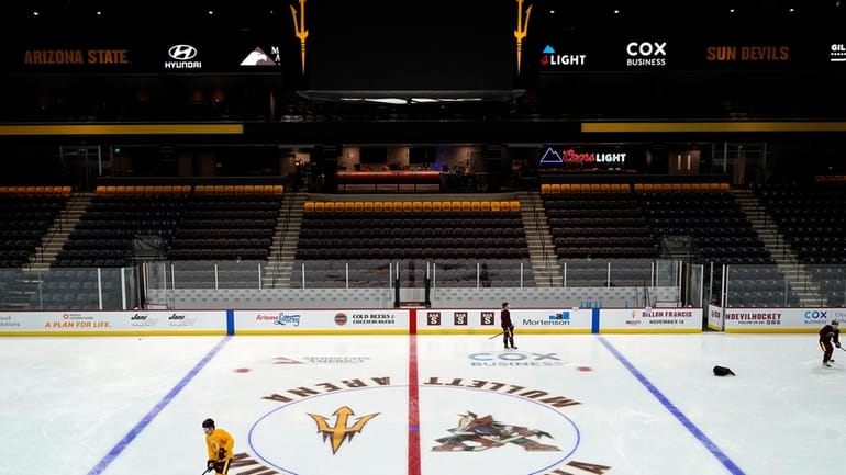 Members of the Arizona State University hockey team skate on...