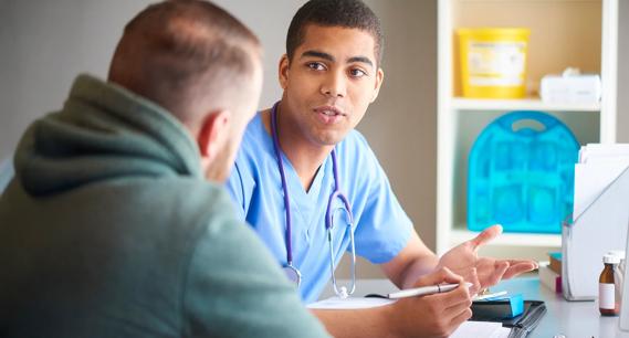 Healthcare provider talking with male patient